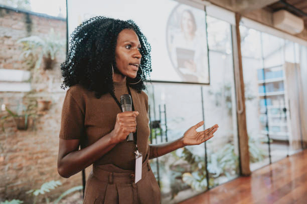 Women with curly hair giving a speech