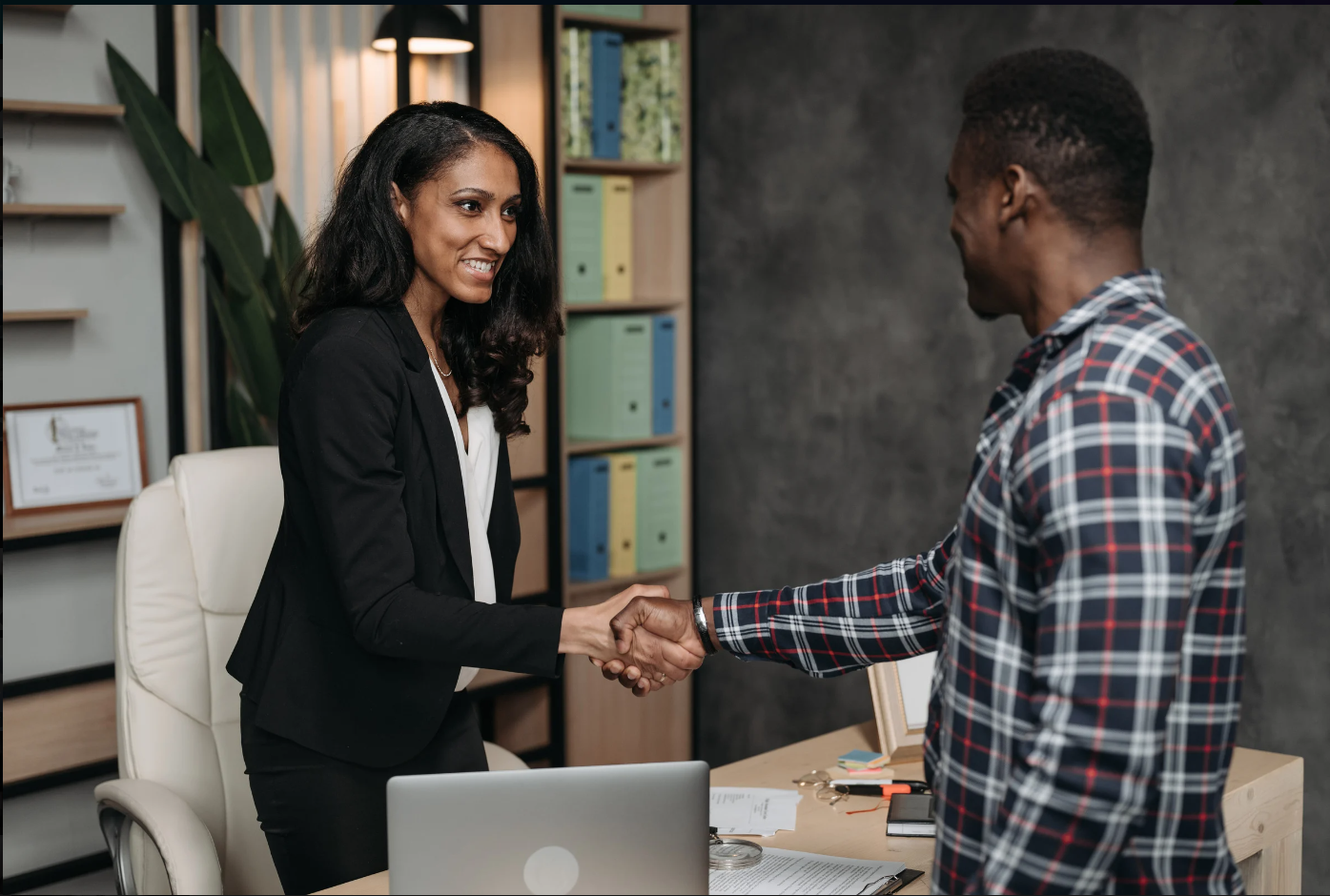 Female lawyer and client doing a handshake